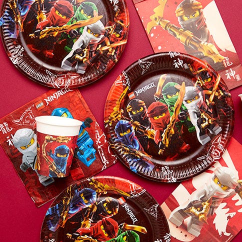 Lego ninjago party supplies arranged in a styled party setting.
