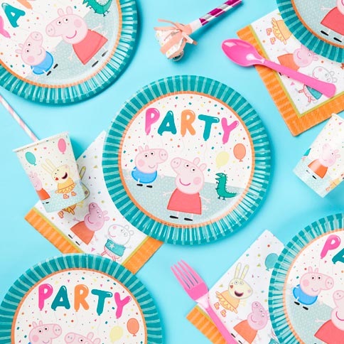 Peppa Pig birthday plates, cups and napkins on a bright turquoise background.